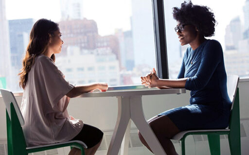 Two women sitting at a table talking